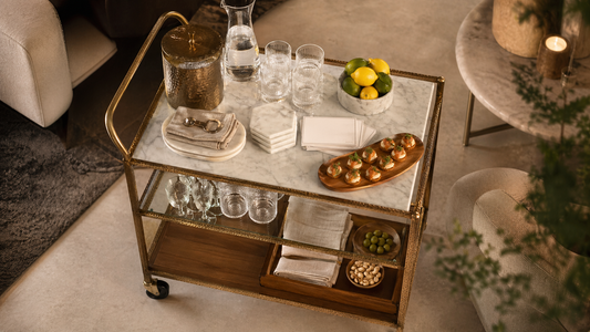 A composed 15-minute hosting setup with TATPUB glassware, marble coasters, teak tray, and hosting system.