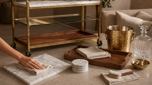 TATPUB marble, brass, glass, and teak hosting pieces arranged with a soft cloth for care guidance.