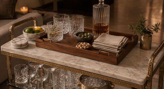 A teak serving tray with glassware, citrus, and linen on the TATPUB hosting system.
