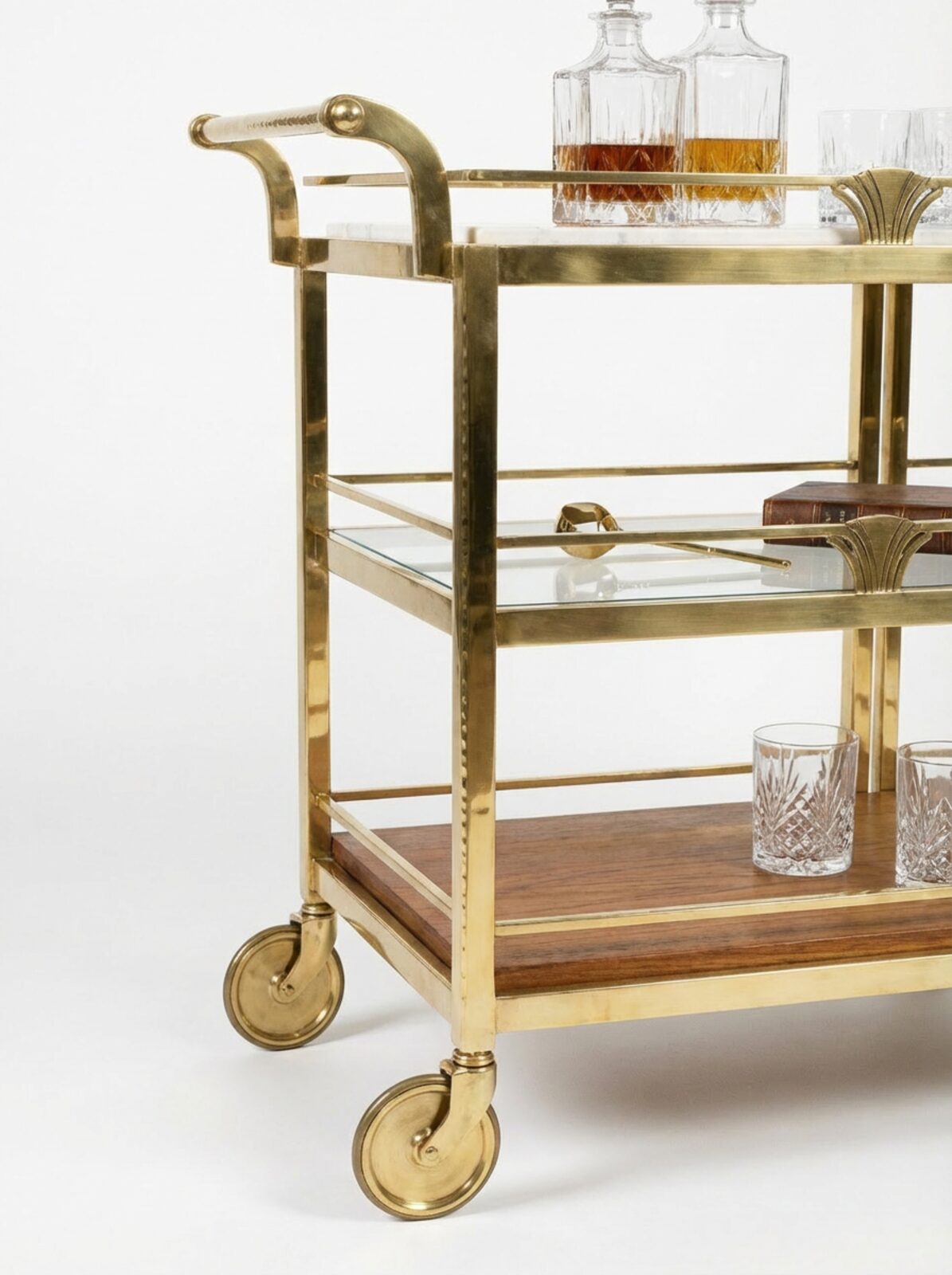 Detail view of TATPUB brass frame, tempered glass shelf, teak-inspired warmth, and locking caster wheel