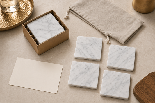 Set of four TATPUB marble coasters arranged as a hosting accessory flat lay