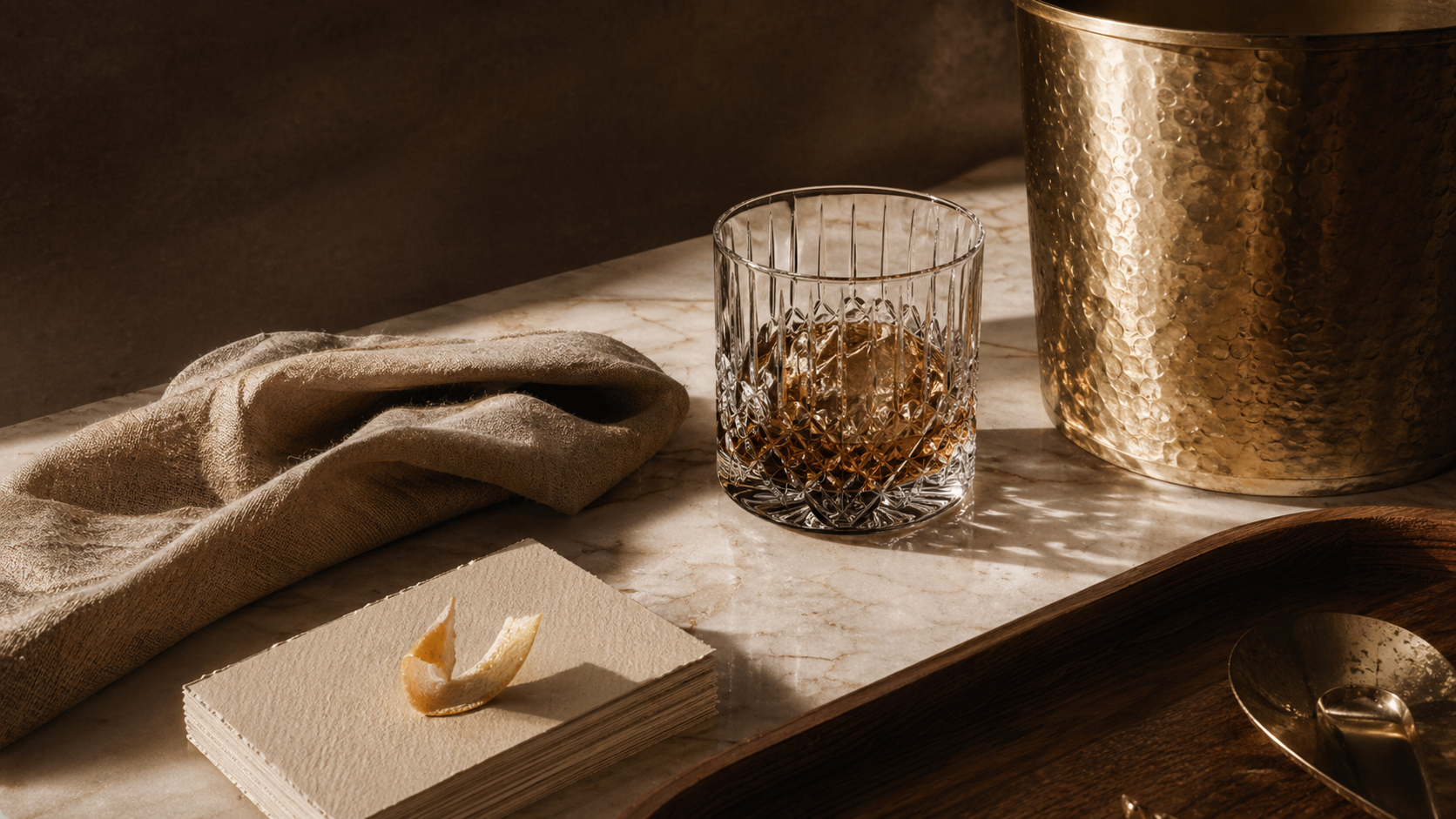 Editorial still life for TATPUB Hosting Journal with marble, brass, glass, linen, and teak.
